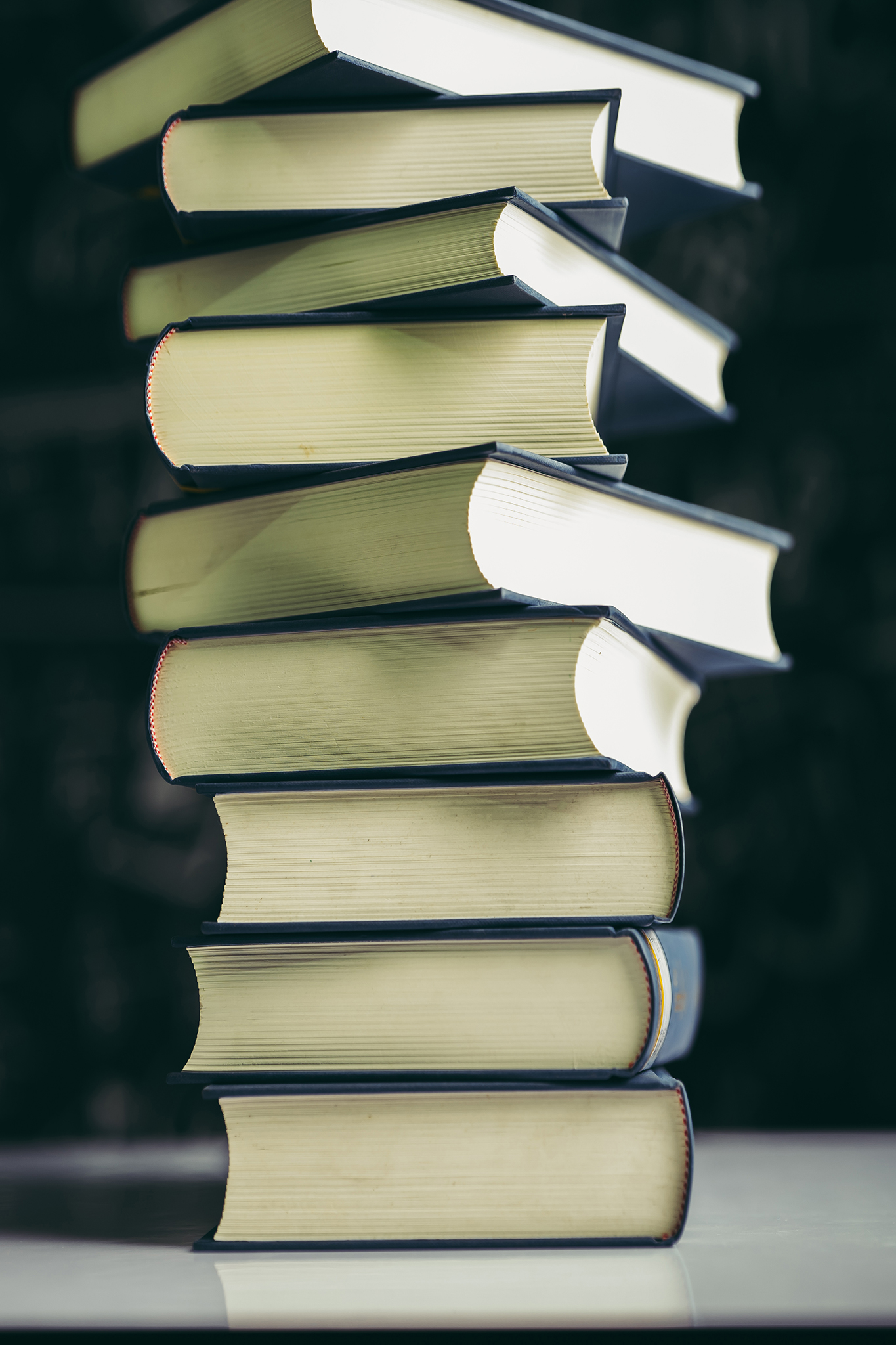 The books are placed in a stack of books on the table